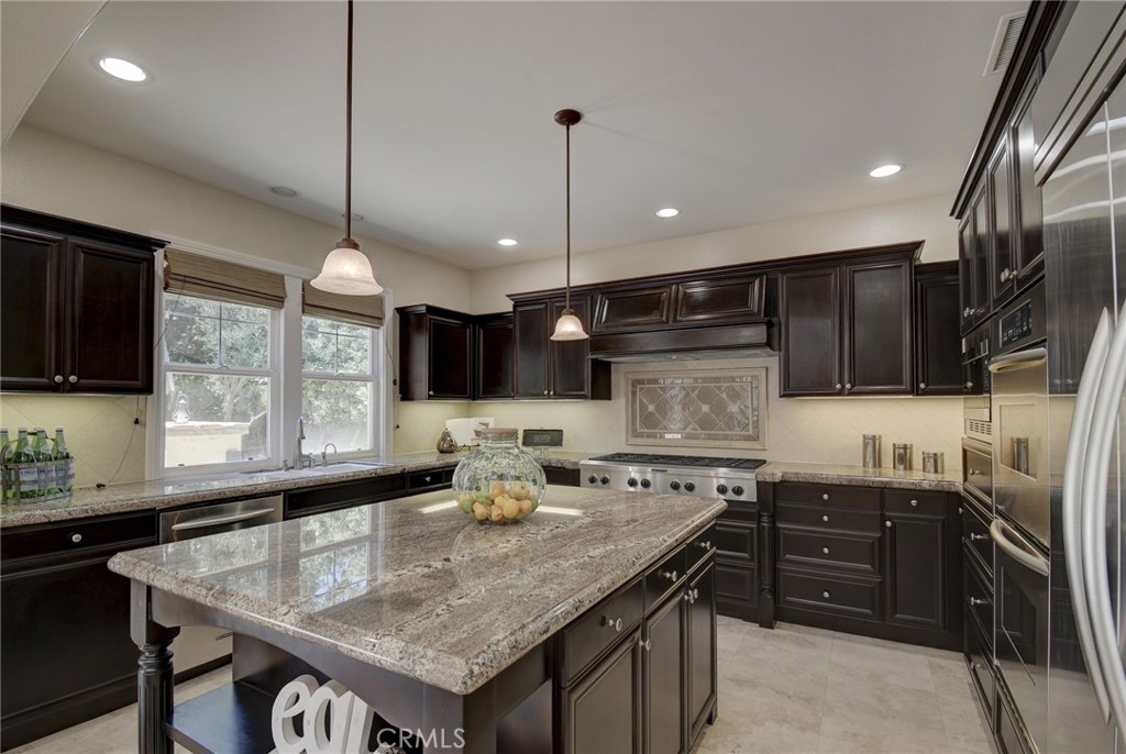 62 Gentry Irvine, CA 92620 - Photo 6 of 48 a kitchen with stainless steel appliances granite countertop a sink a stove and a wooden cabinets