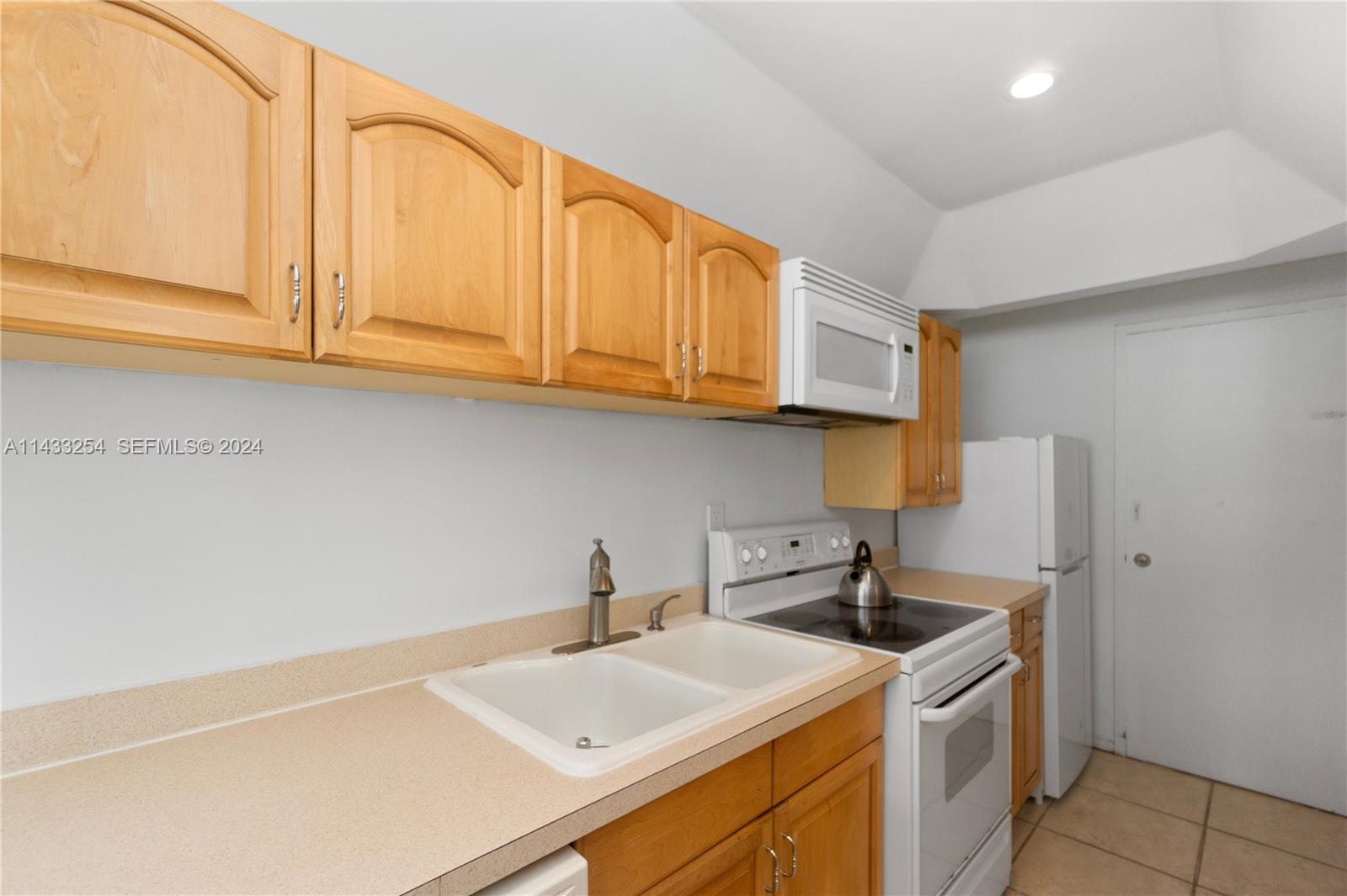 100 Lincoln Road, Unit 1039 Miami Beach, FL 33139 - Photo 15 of 26 a kitchen with stainless steel appliances granite countertop a sink and a white cabinets