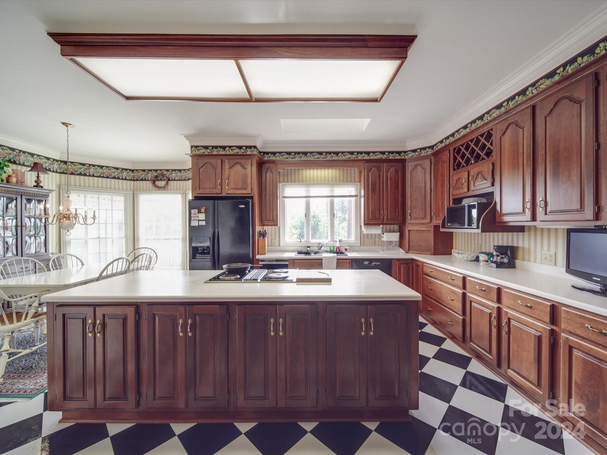 205 James Road Oakboro, NC 28129 - Photo 15 of 48 a kitchen with kitchen island granite countertop a sink stove and cabinets