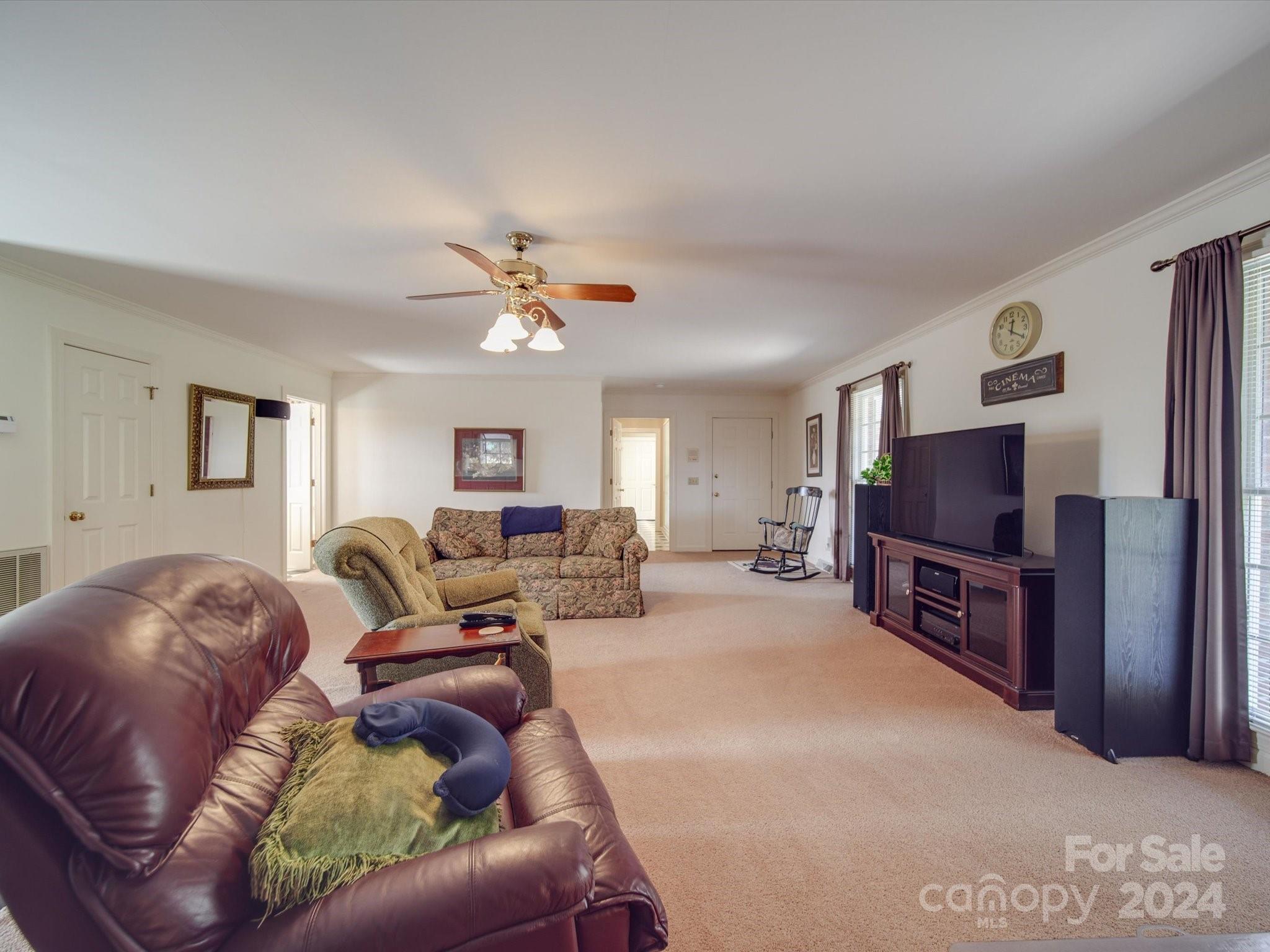 205 James Road Oakboro, NC 28129 - Photo 33 of 48 a living room with furniture a flat screen tv and a chandelier