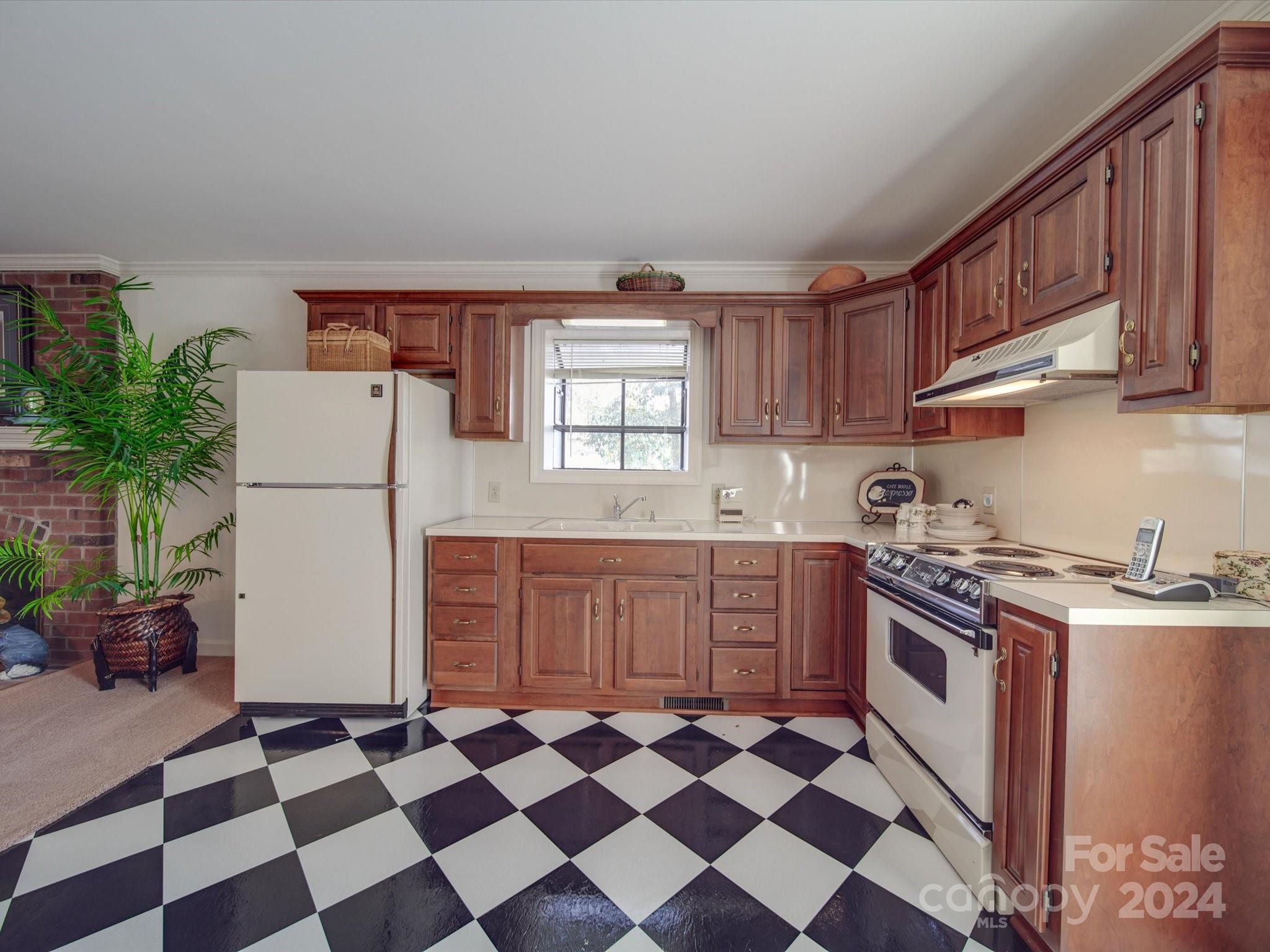 205 James Road Oakboro, NC 28129 - Photo 35 of 48 a kitchen with granite countertop stainless steel appliances a stove a sink and a window