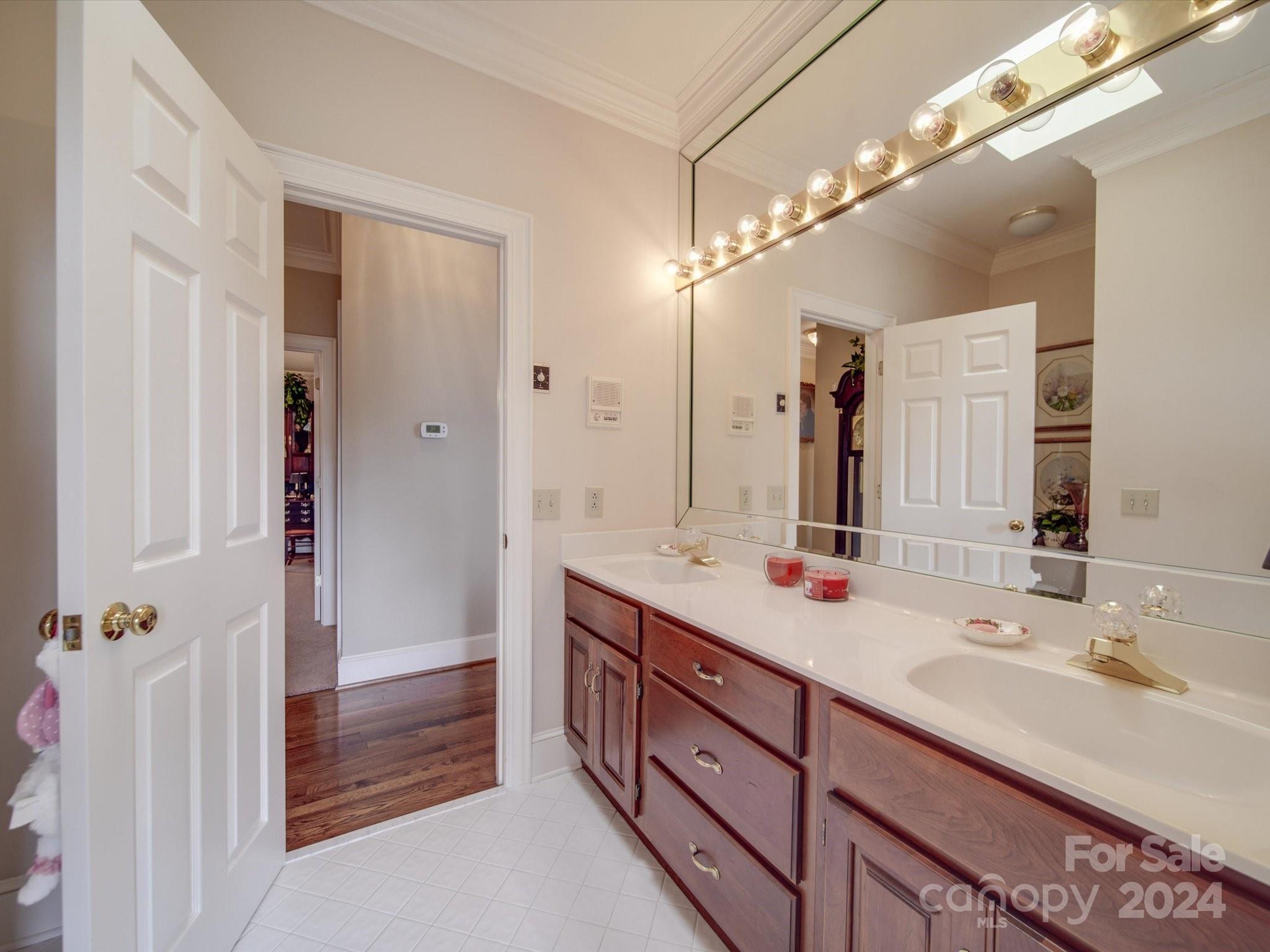 205 James Road Oakboro, NC 28129 - Photo 40 of 48 a bathroom with a double vanity sink a large mirror and a shower