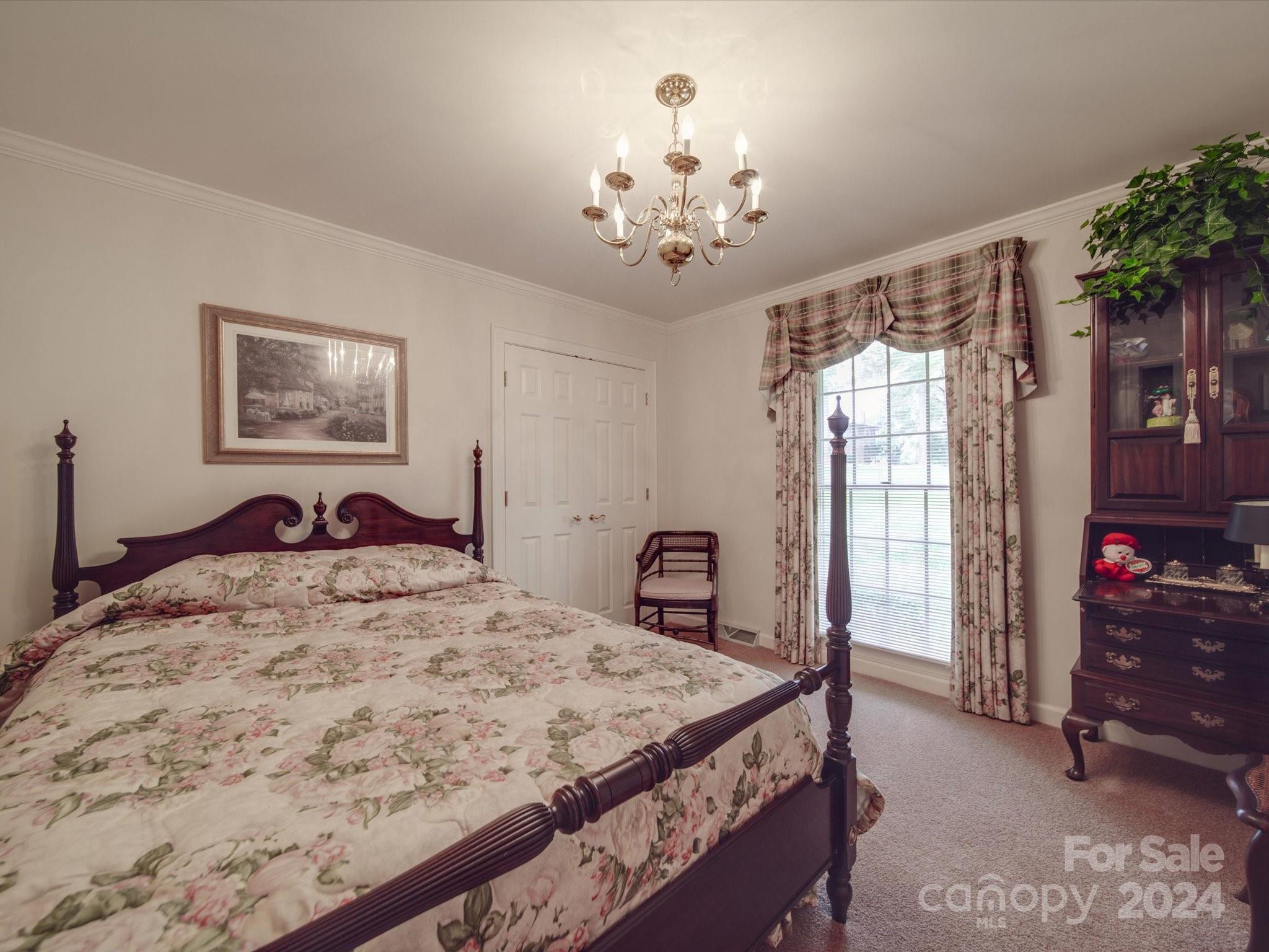 205 James Road Oakboro, NC 28129 - Photo 42 of 48 a bed sitting in a bedroom and chandelier