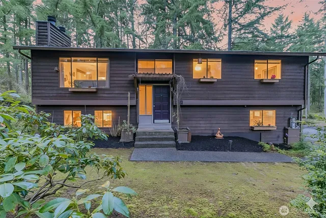 a front view of a house with a yard and an outdoor seating
