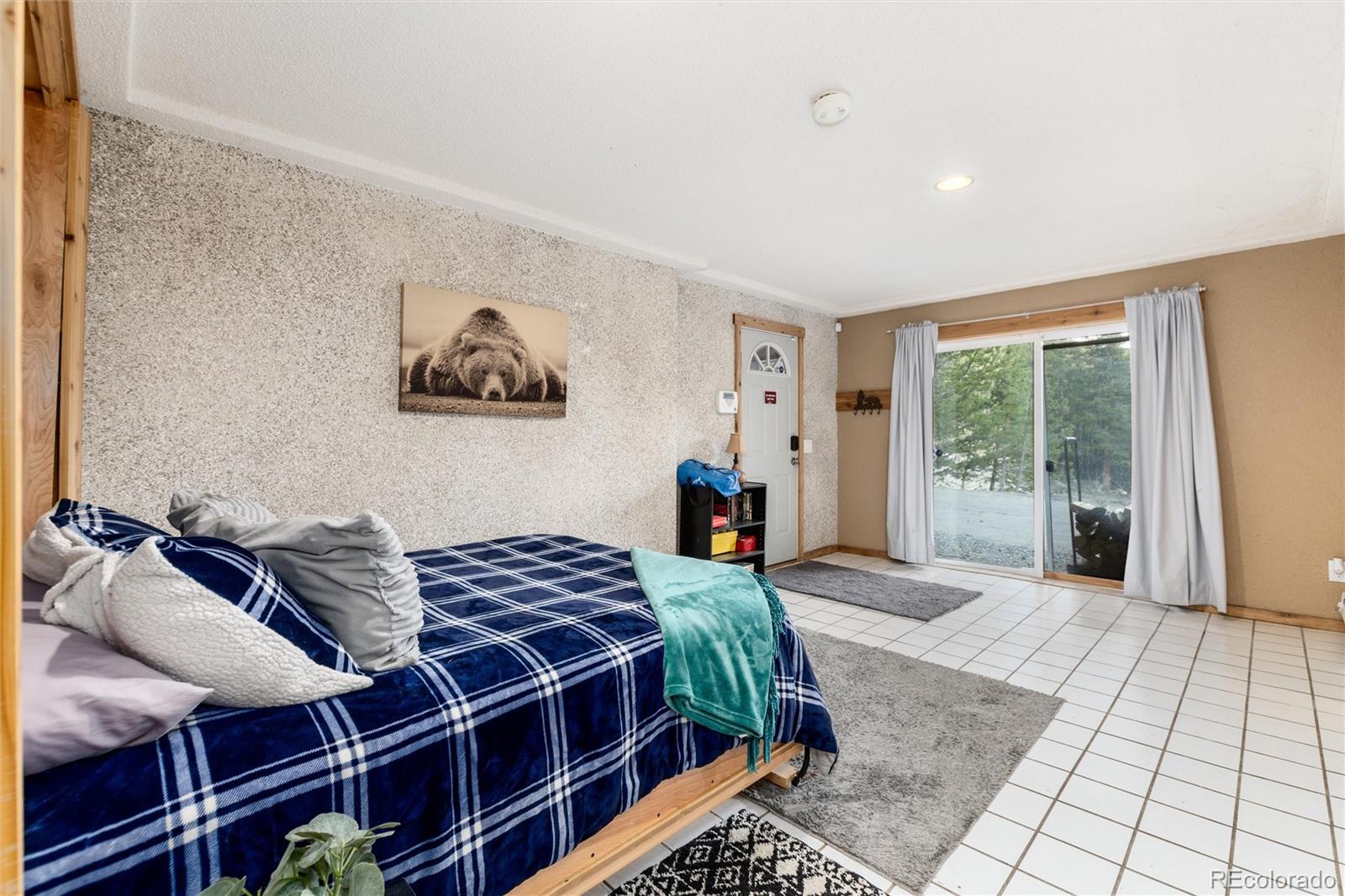 159 Lake Road Idaho Springs, CO 80452 - Photo 20 of 45 a bedroom with a bed and a large window