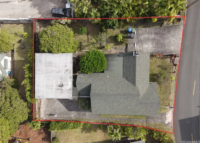 an aerial view of a house with a yard