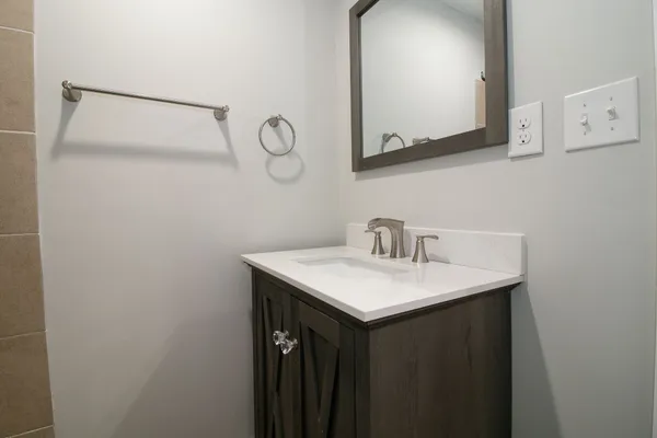 a bathroom with a sink and a mirror