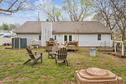 a swimming pool with outdoor seating and yard