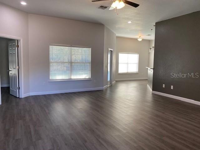 9050 Northeast 80th Street Bronson, FL 32621 - Photo 2 of 12 an empty room with wooden floor and windows