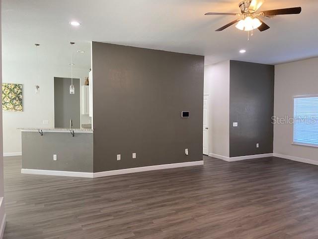 9050 Northeast 80th Street Bronson, FL 32621 - Photo 4 of 12 a view of room with window ceiling fan and hardwood floor