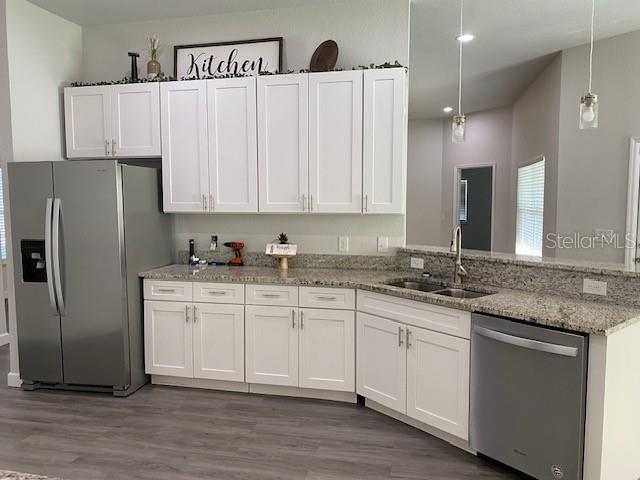 9050 Northeast 80th Street Bronson, FL 32621 - Photo 5 of 12 a kitchen with stainless steel appliances granite countertop a refrigerator sink and cabinets