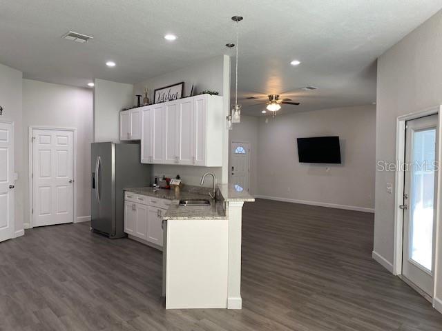 9050 Northeast 80th Street Bronson, FL 32621 - Photo 9 of 12 a kitchen with a refrigerator and a stove top oven