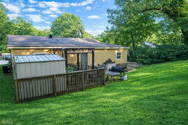 a view of a backyard with a sitting area and a wooden deck