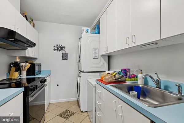 a kitchen with refrigerator and cabinets