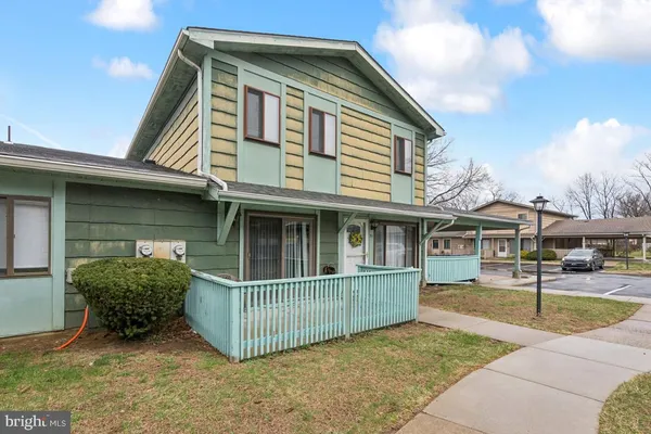 a view of a house with a yard and fence