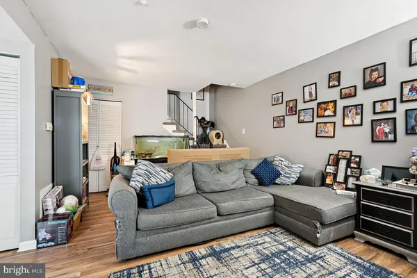 a living room with furniture and painting on the wall