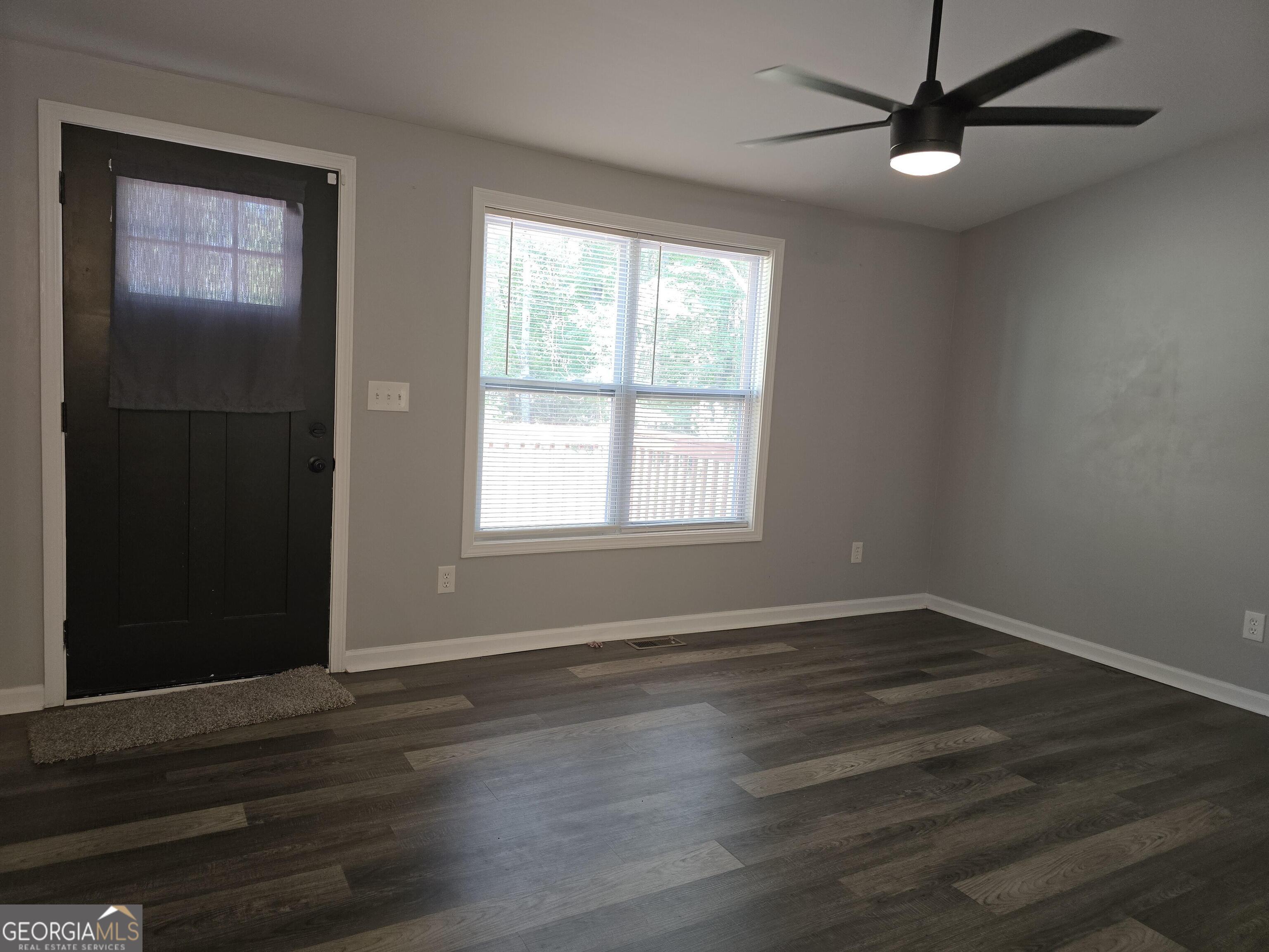 1109 Liberty Church Road Bremen, GA 30110 - Photo 12 of 26 a view of an empty room with wooden floor and a window