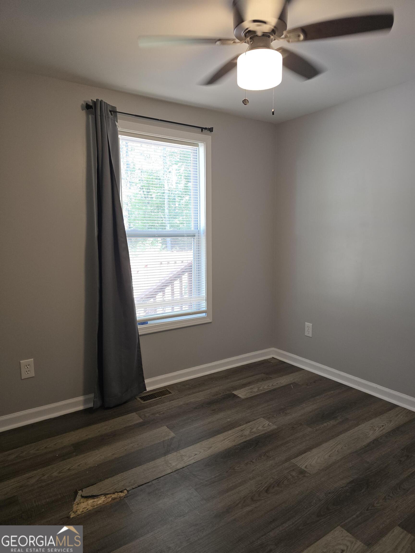 1109 Liberty Church Road Bremen, GA 30110 - Photo 13 of 26 a view of an empty room with wooden floor and a window