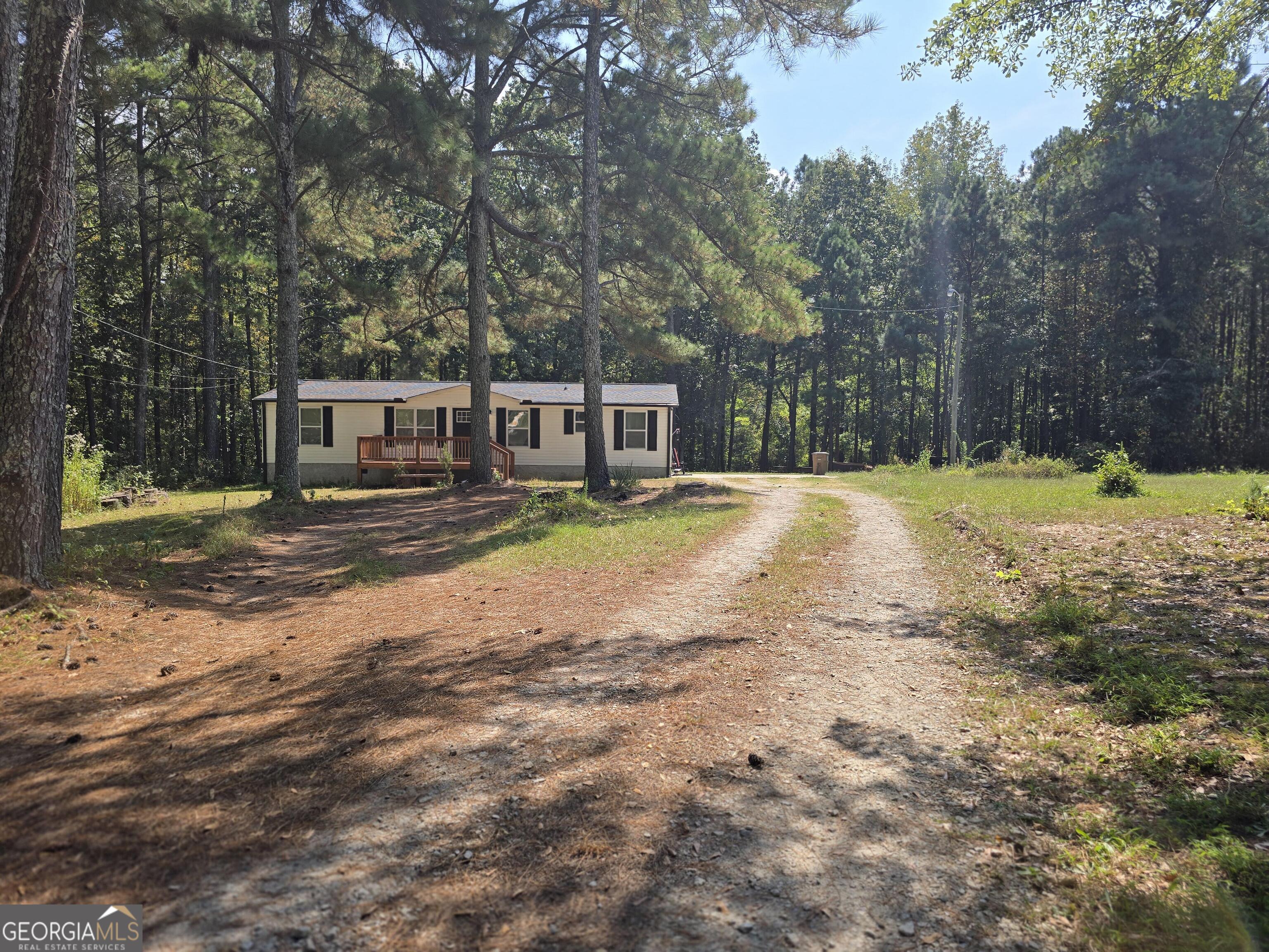 1109 Liberty Church Road Bremen, GA 30110 - Photo 2 of 26 a view of a house with a yard covered with snow and trees
