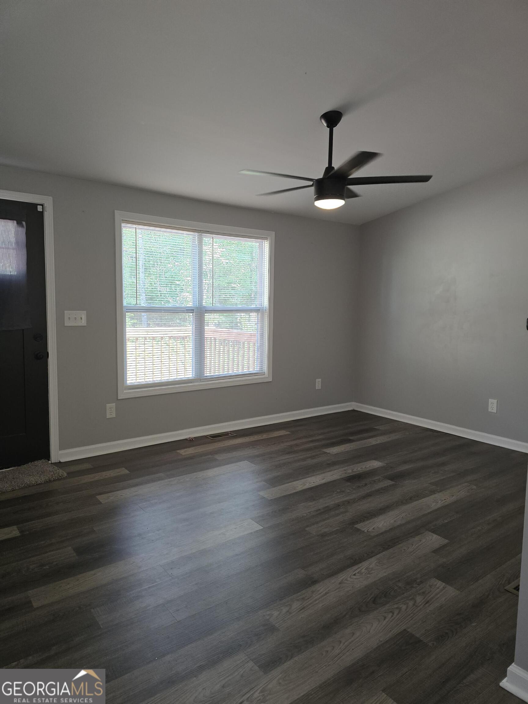 1109 Liberty Church Road Bremen, GA 30110 - Photo 7 of 26 a view of an empty room with wooden floor and a window