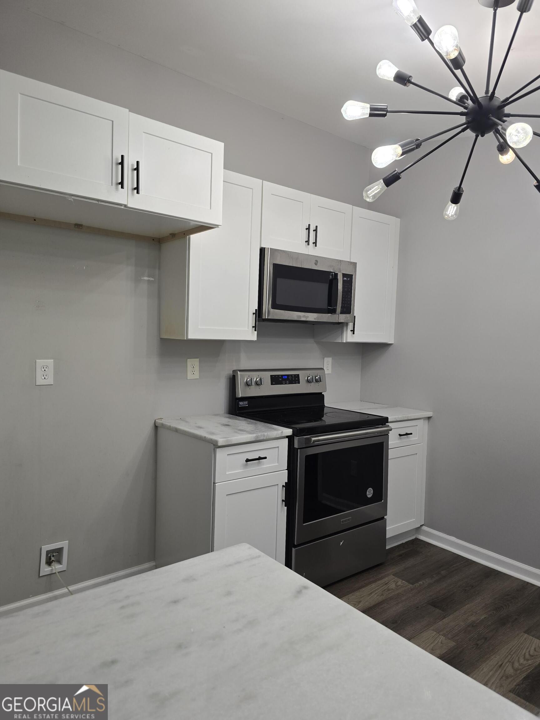 1109 Liberty Church Road Bremen, GA 30110 - Photo 8 of 26 a kitchen with stainless steel appliances a sink a stove a microwave and cabinets