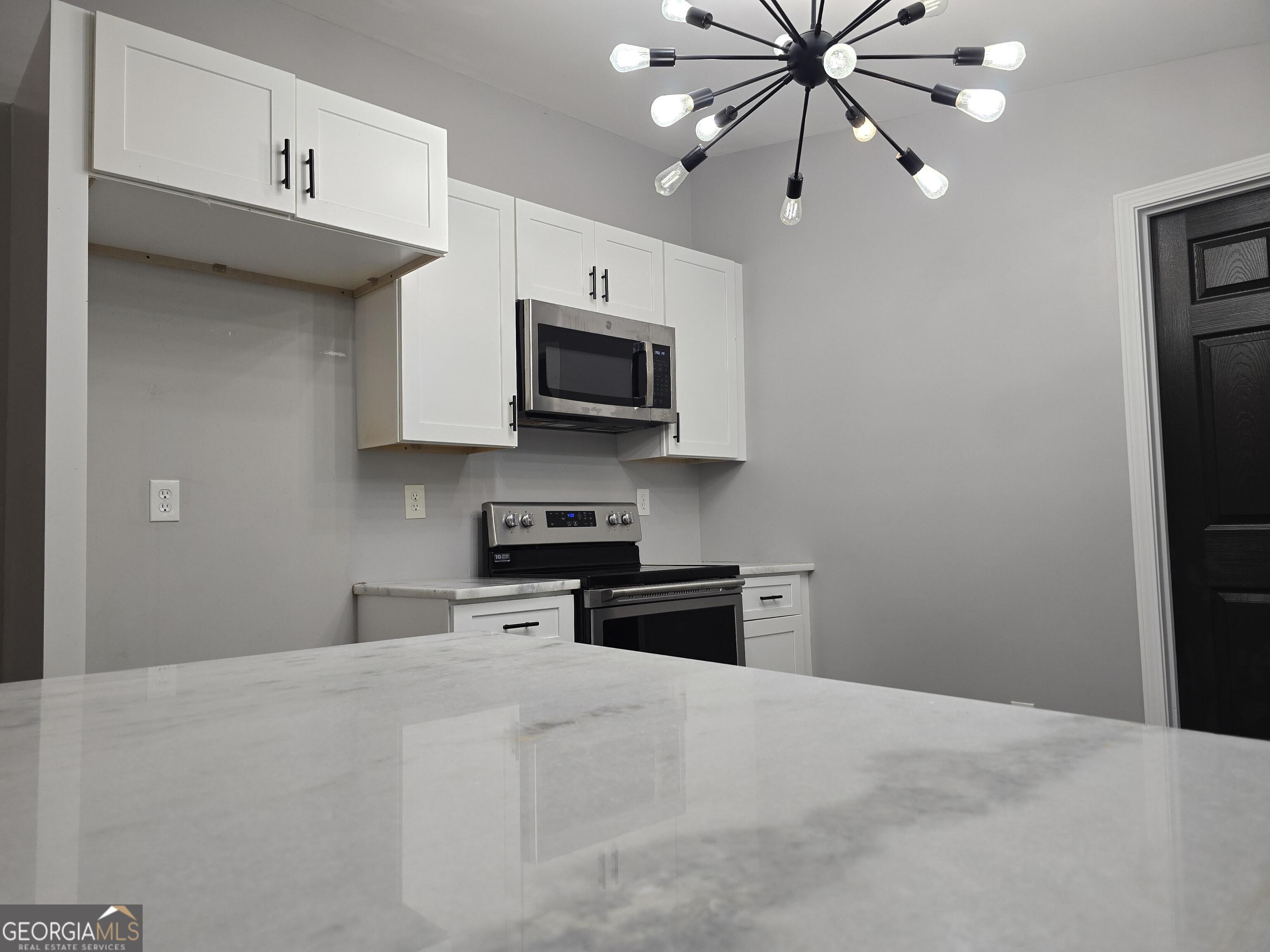 1109 Liberty Church Road Bremen, GA 30110 - Photo 10 of 26 a kitchen with stainless steel appliances a stove sink microwave and cabinets