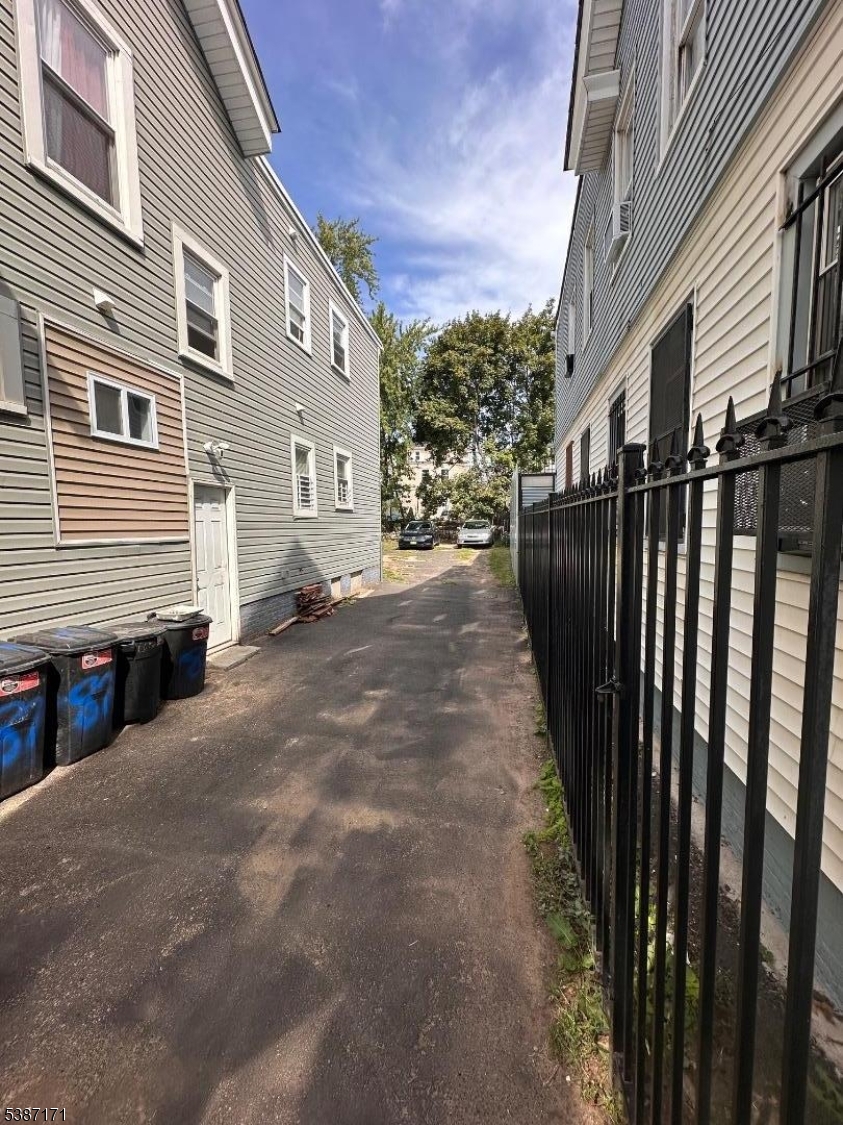 87 Lyons Avenue Newark, NJ 07112 - Photo 2 of 13 a view of a house with a street