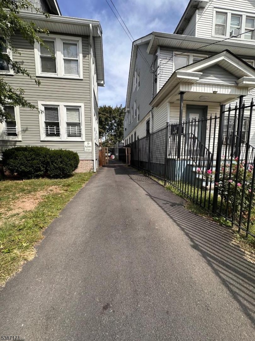 87 Lyons Avenue Newark, NJ 07112 - Photo 3 of 13 a view of a house with a yard
