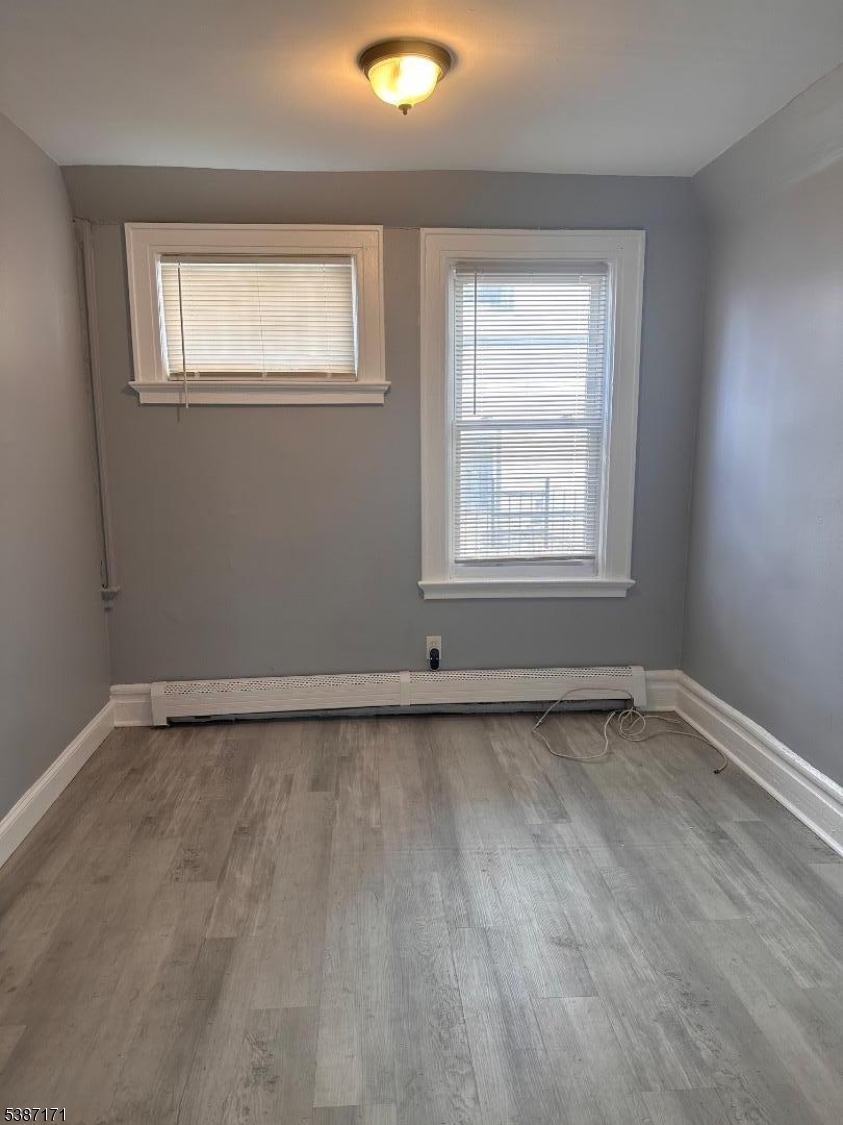 87 Lyons Avenue Newark, NJ 07112 - Photo 6 of 13 an empty room with a window