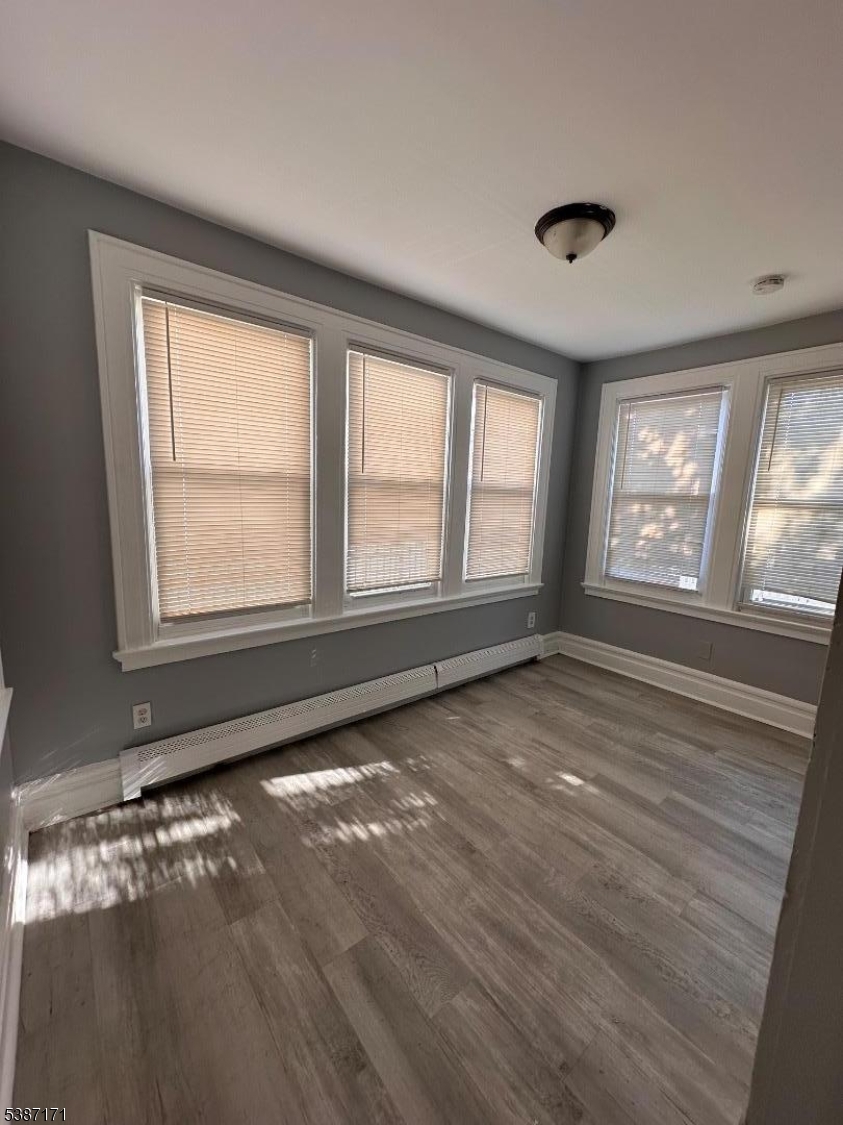 87 Lyons Avenue Newark, NJ 07112 - Photo 7 of 13 a view of an empty room with a window