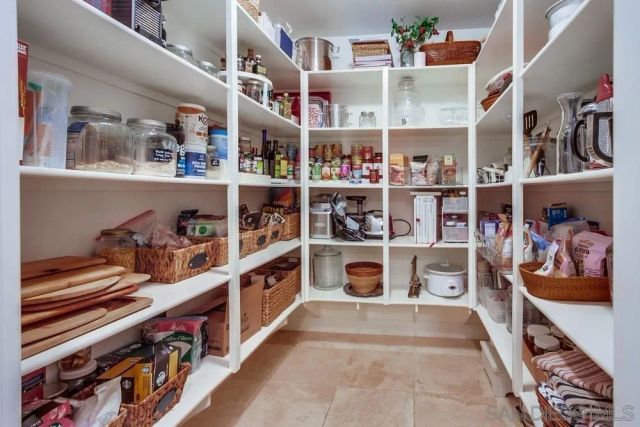 a large bedroom with a large bed and tv