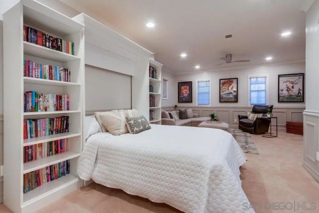 a living room with furniture and a kitchen