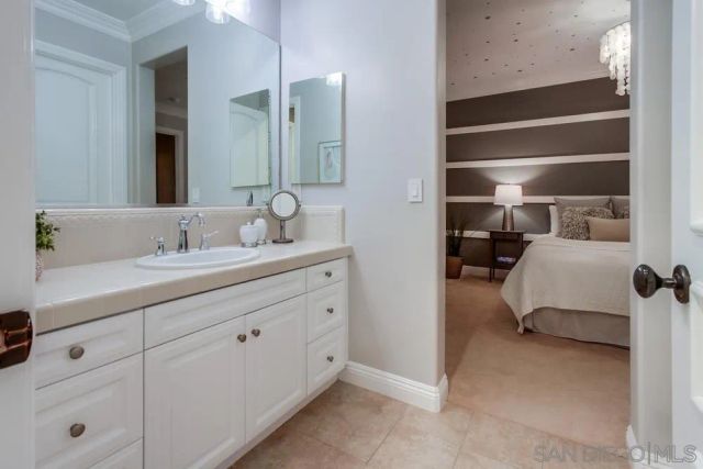 a bedroom with a bed and a large mirror