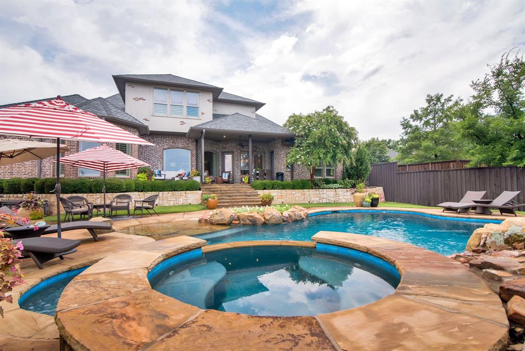 a swimming pool with outdoor seating and yard