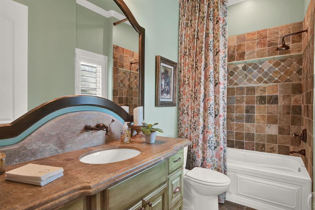 2921 Sedalia Trail Sherman, TX 75092 - Photo 20 of 40 a bathroom with a granite countertop sink a toilet a mirror and shower