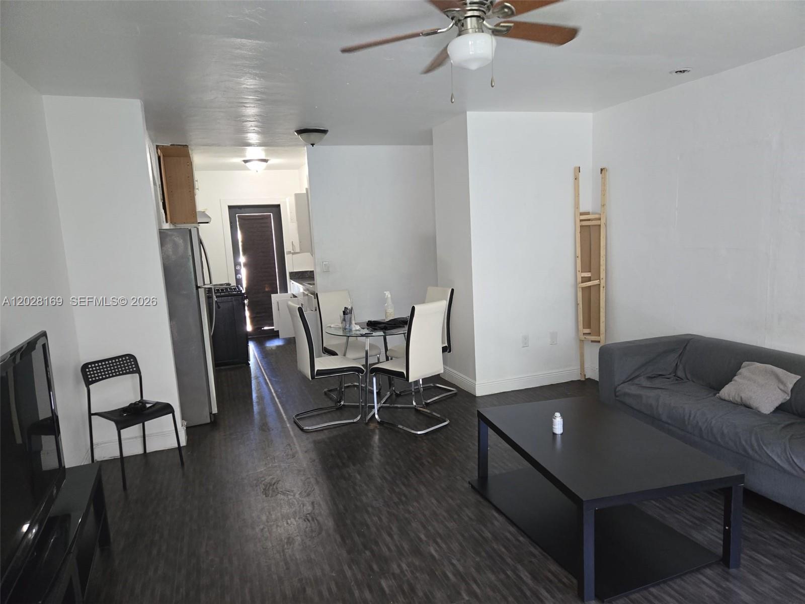 7035 Rue Granville, Unit 2 Miami Beach, FL 33141 - Photo 1 of 6 a living room with furniture and a table