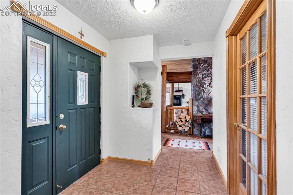 209 Rosewood Road Westcliffe, CO 81252 - Photo 8 of 49 Tile floors and coat closet upon entry, with glass door to the office/living room