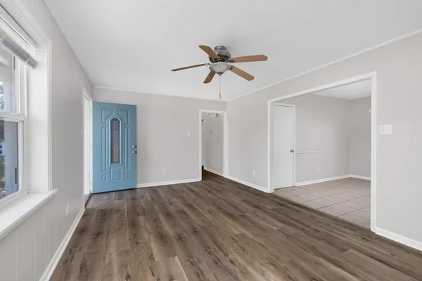 wooden floor in an empty room with a window