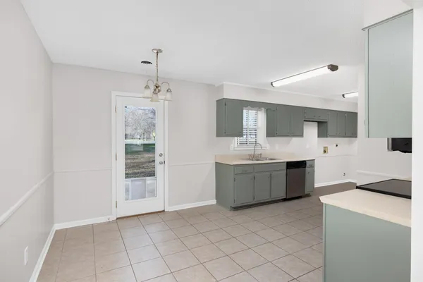 an empty room with windows and ceiling fan