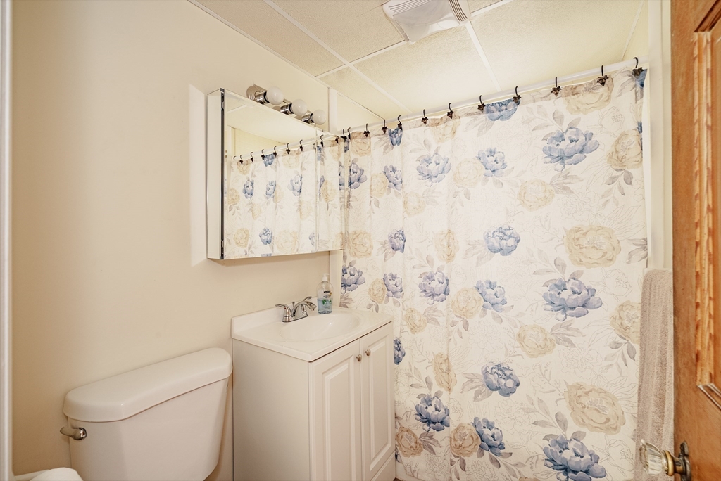 94 Holly Street Springfield, MA 01151 - Photo 11 of 41 a bathroom with a toilet sink and mirror