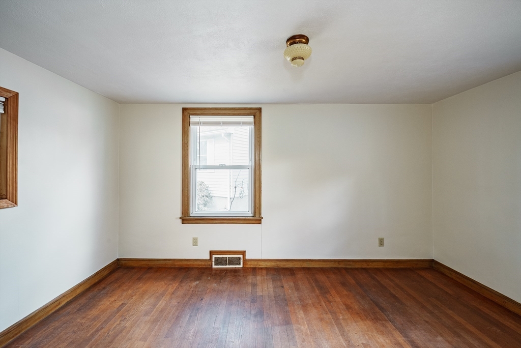 94 Holly Street Springfield, MA 01151 - Photo 15 of 41 an empty room with wooden floor and windows