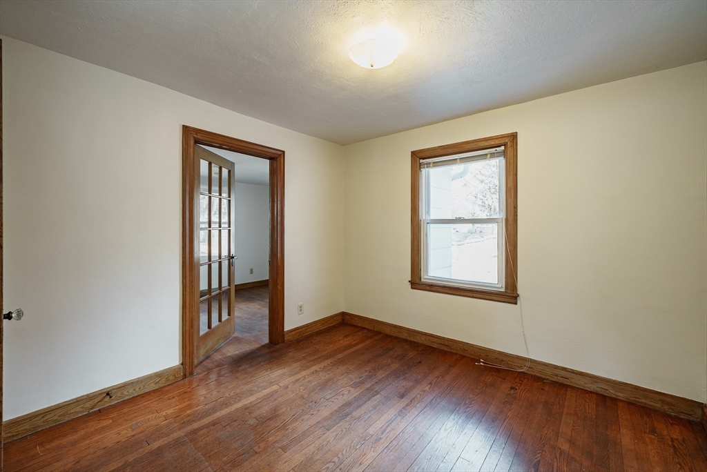 94 Holly Street Springfield, MA 01151 - Photo 16 of 41 an empty room with wooden floor and windows