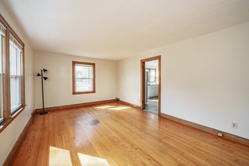 94 Holly Street Springfield, MA 01151 - Photo 2 of 41 an empty room with wooden floor and windows