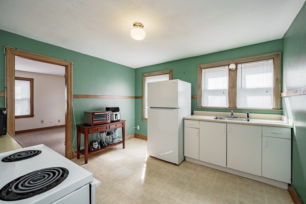 94 Holly Street Springfield, MA 01151 - Photo 24 of 41 a kitchen with a refrigerator and a stove