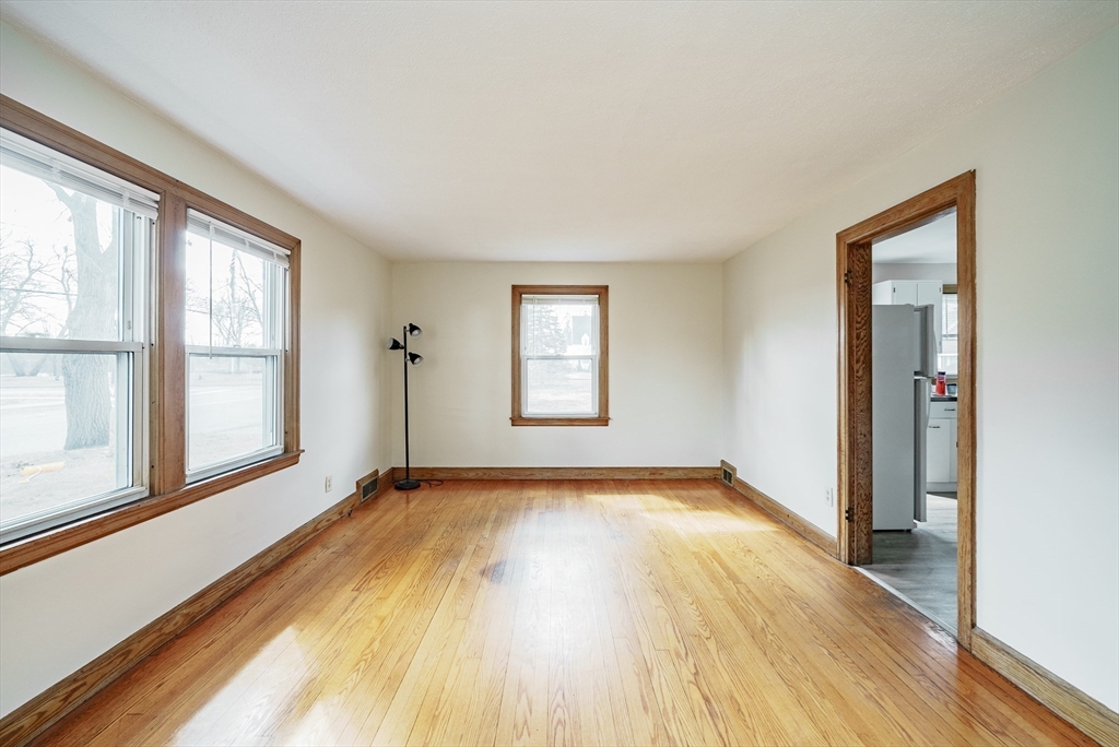 94 Holly Street Springfield, MA 01151 - Photo 4 of 41 wooden floor in an empty room with a window