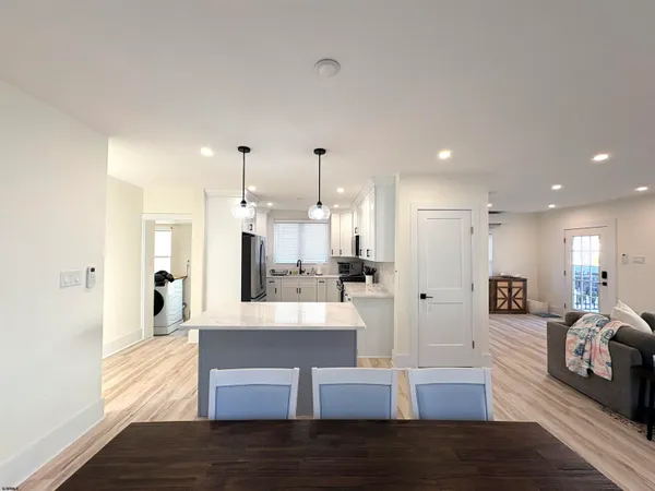 a view of a living room kitchen and a wooden floor