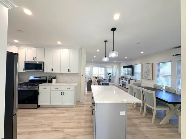 a large kitchen with kitchen island a large island in the center