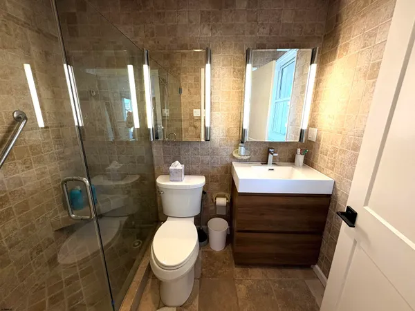 a bathroom with a sink toilet and shower