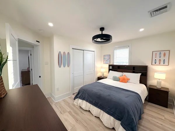 a bedroom with a bed and a chandelier