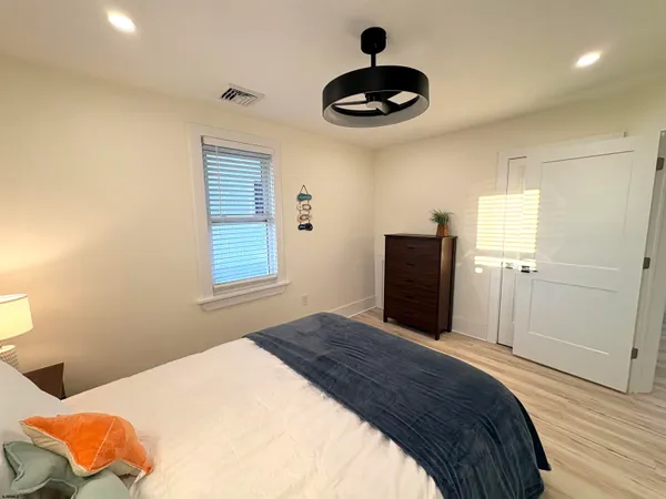 a bedroom with a bed and a chandelier